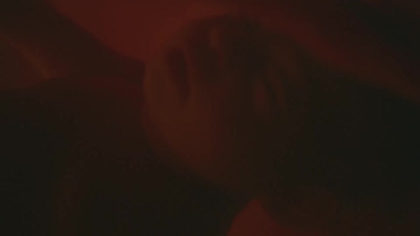 A baby is shown floating in amniotic fluid with white and red lights