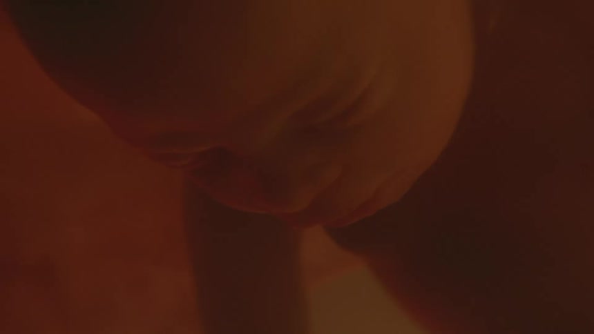 A face of a baby floating with eyes closed