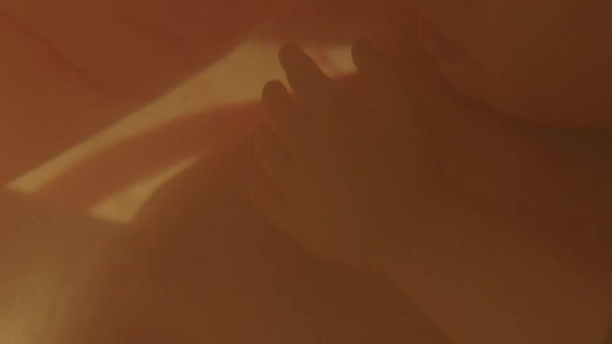 A fetus gently floats inside of a uterus full of amniotic fluid