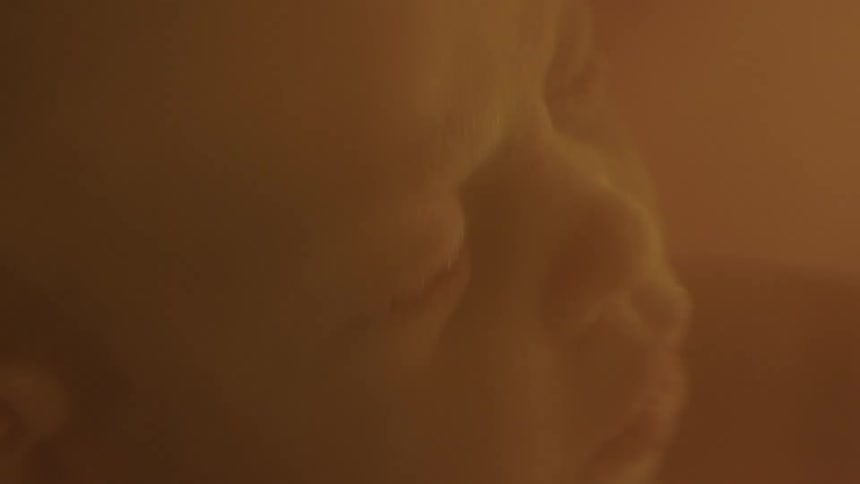 Light shines and fades on the face of an unborn baby