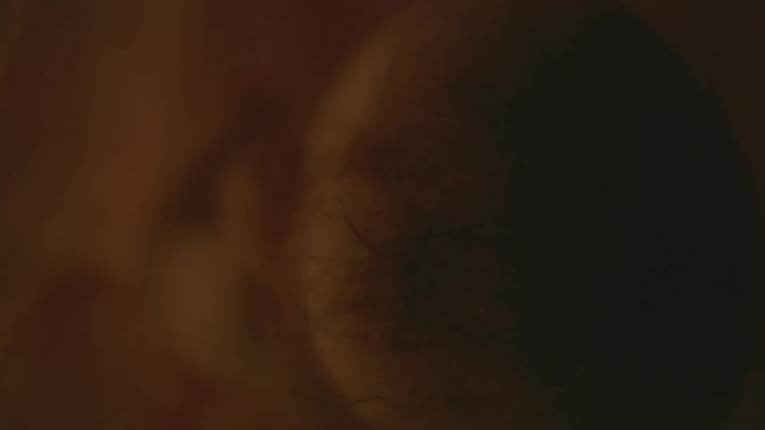A fetus floats calmly inside of a uterus full of amniotic fluid