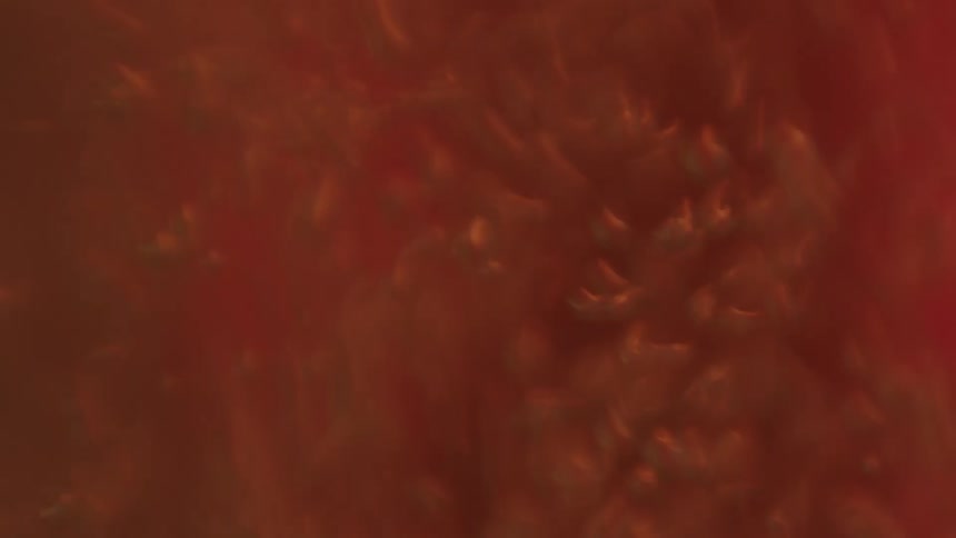 Liquid moving rapidly with bubbles and flashing red and white light