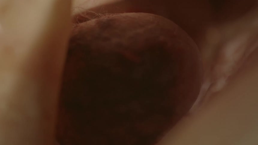 A babys head with hair showing surrounded by fabric