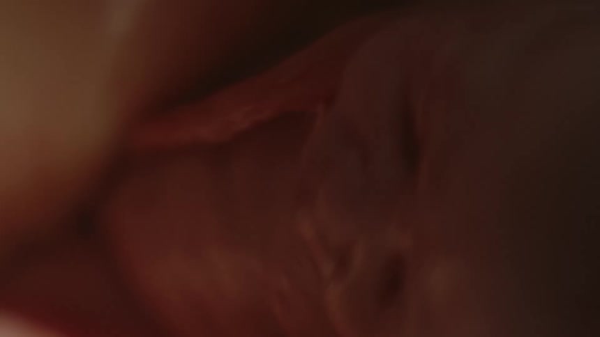 A baby is in utero with a partial face visible