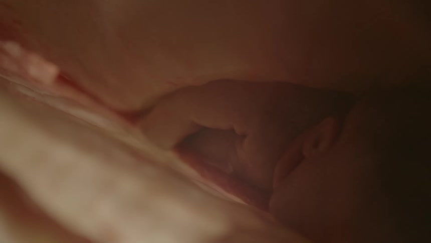 Unborn human baby laying face down inside the womb