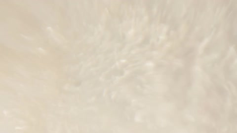 Liquid is moving rapidly and swirling around creating bubbles