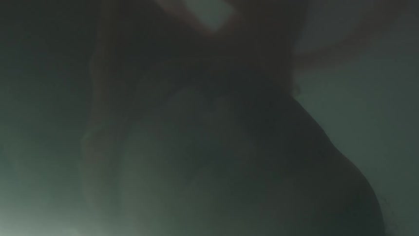 Light glows on an unborn baby with umbilical cord floating in fluid