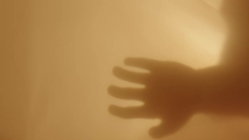 A babys hand and arm are visible as dark turns to light