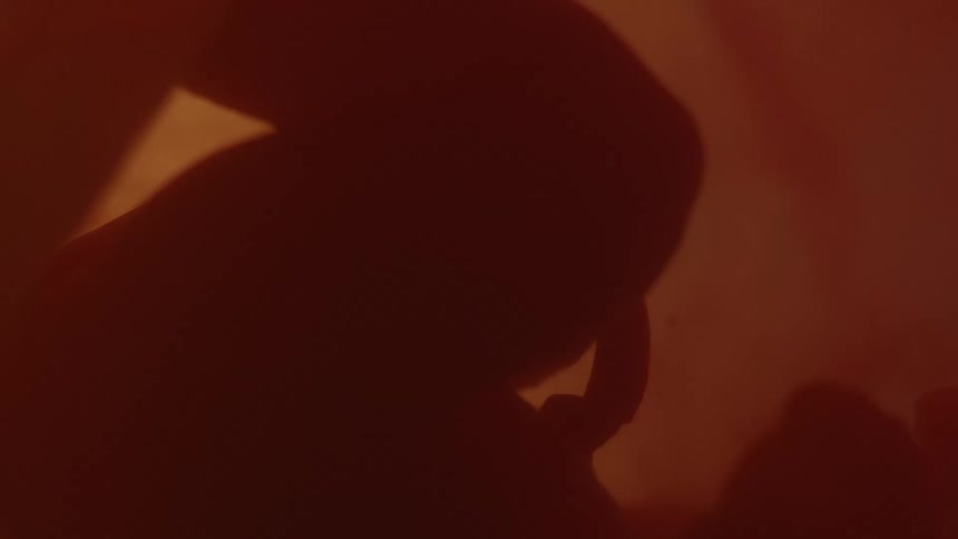 Close up of unborn babys legs and arms in the womb