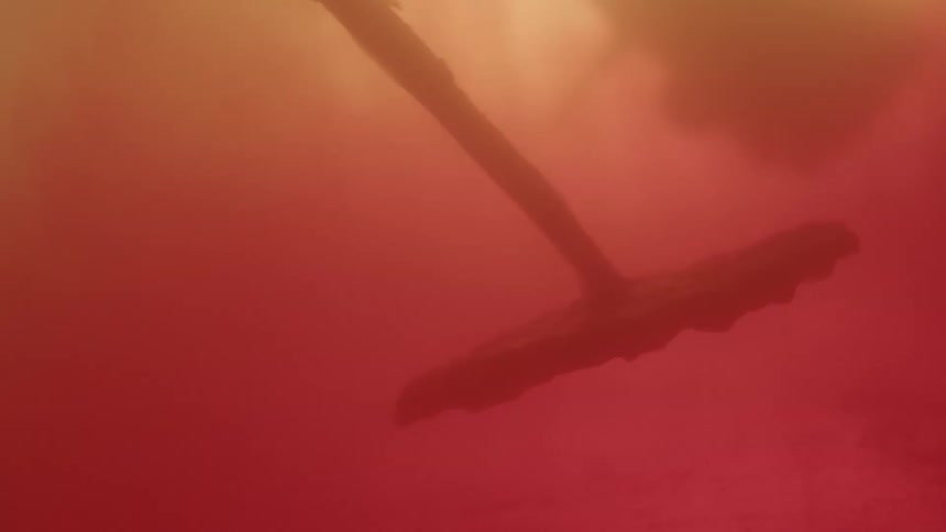 Object floating in liquid with pink red and white lights