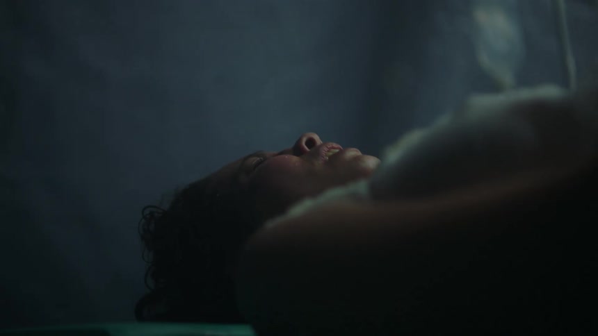 A woman is laying on the ground and is in pain