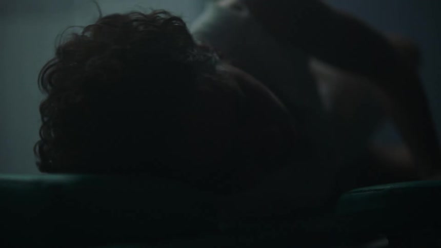 A pregnant woman laboring on a hospital bed