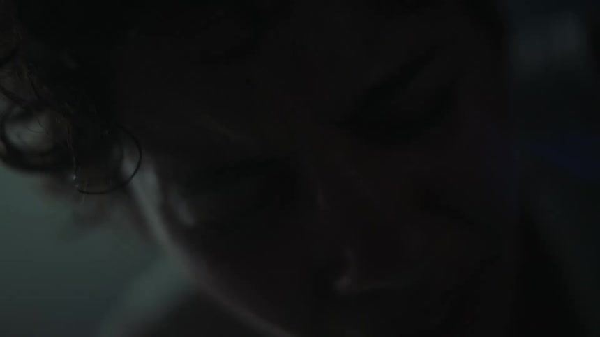A close up of a woman having trouble breathing