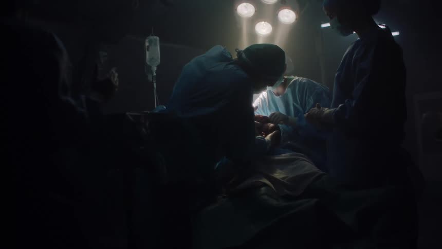 A doctor delivers a baby through a c section