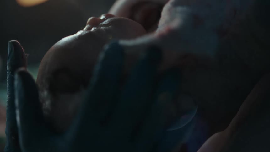A newborn baby being wiped off after delivery