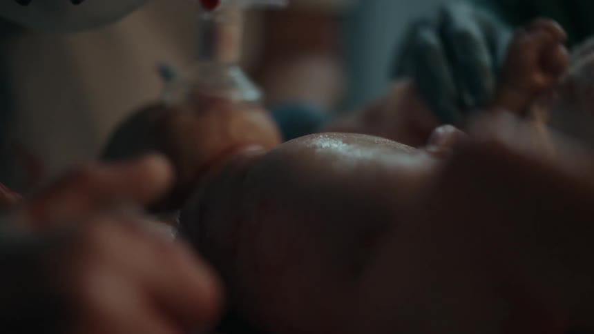 Medical personnel take care of newborn in delivery room
