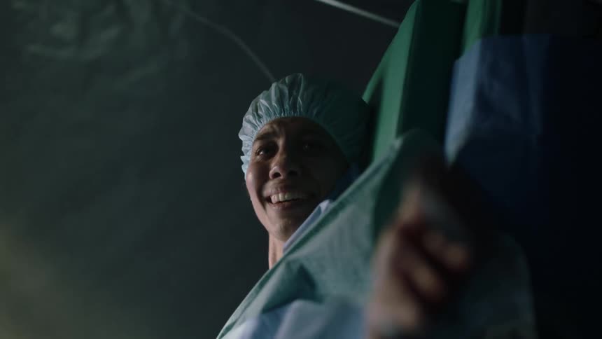 A nurse handing a new mom her newborn after delivery