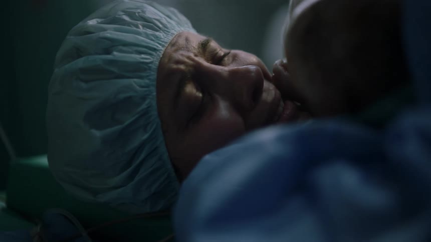 A new mother crying after giving birth in a hospital
