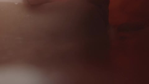 Unborn human baby surrounded by amniotic liquid inside the womb