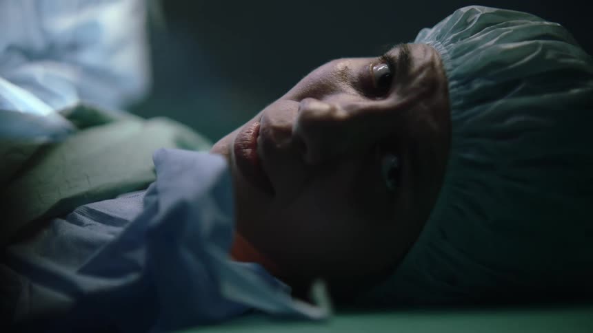 A woman lying in a hospital bed