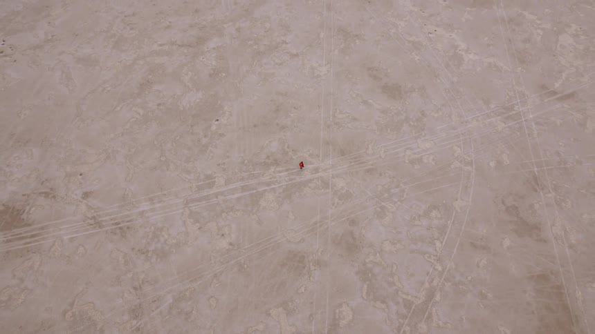 Aerial view of a person walking over a deserted area
