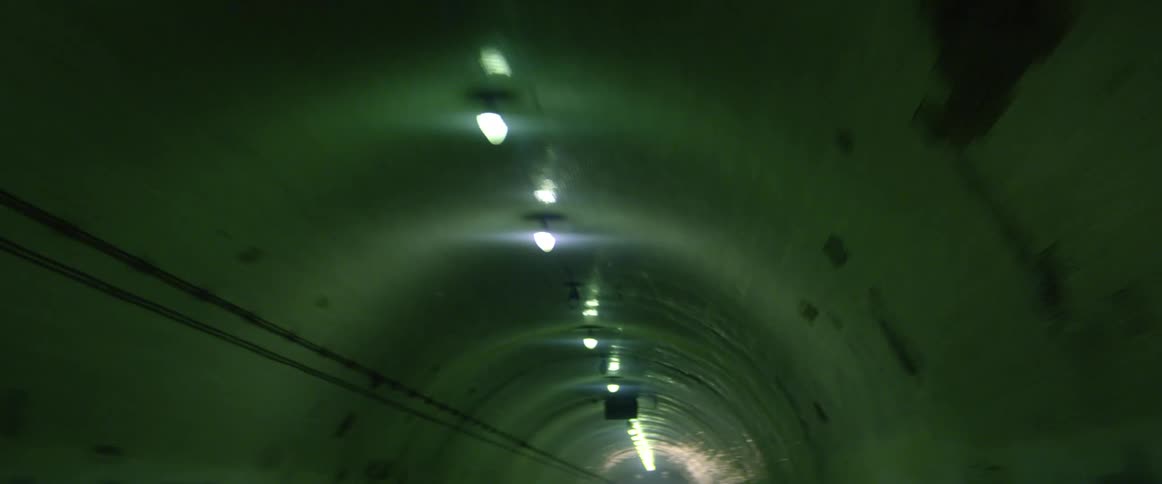 A tunnel with lights and cables on the interior