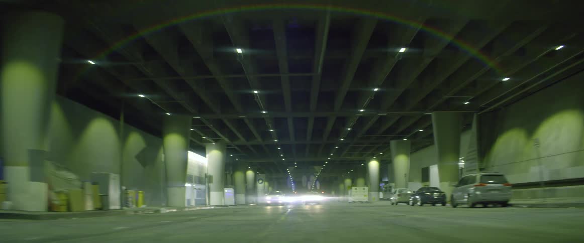 A motorcycle speeds past other vehicles driving through a tunnel