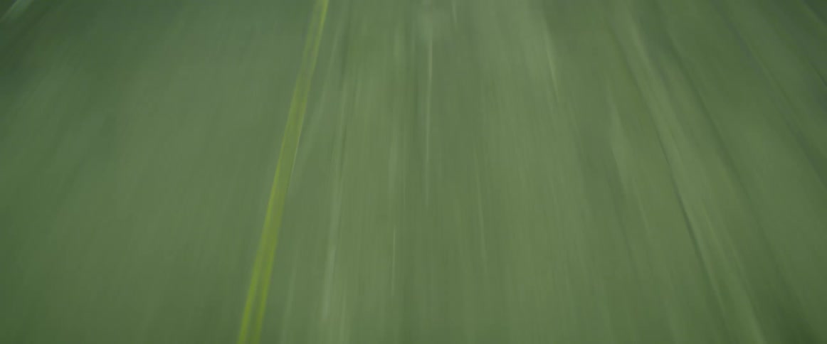 Motorcycle races towards us at high speeds