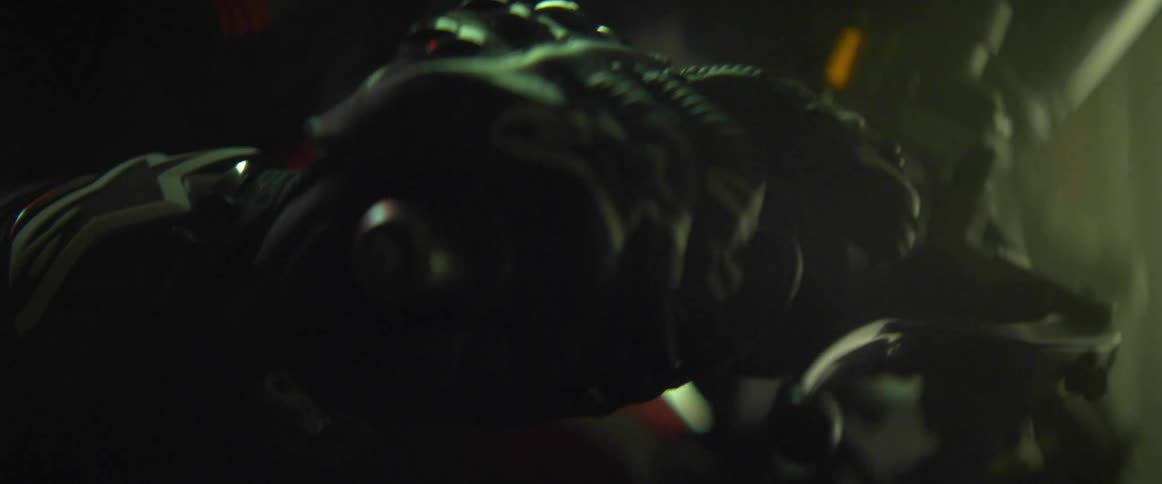 Close up of a gloved hand rolling on the throttle in the handlebar of a motorcycle at night