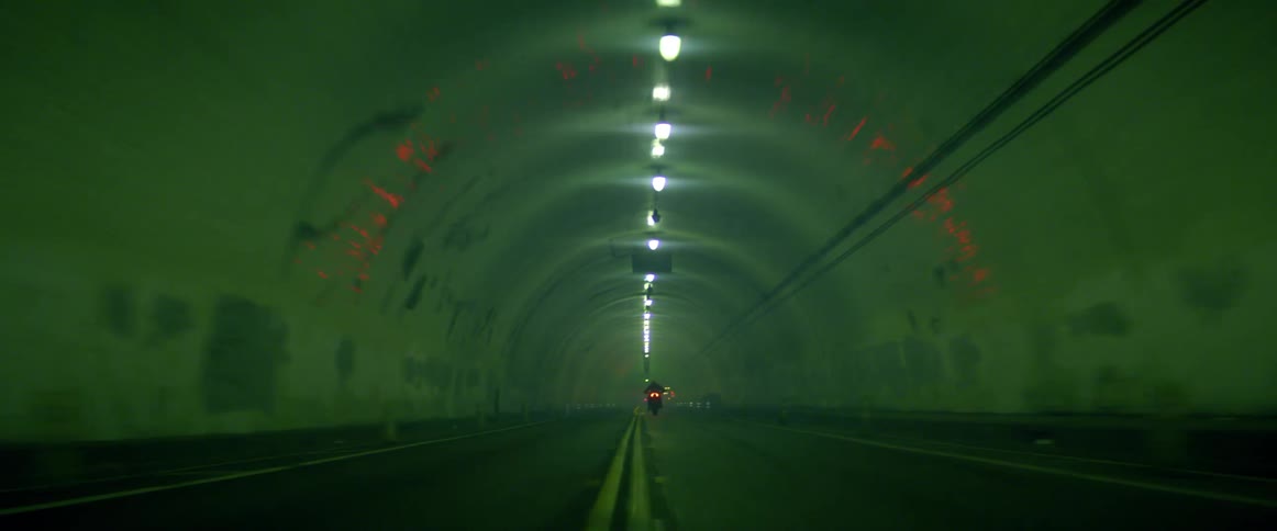 A person driving a motorcycle in a tunnel