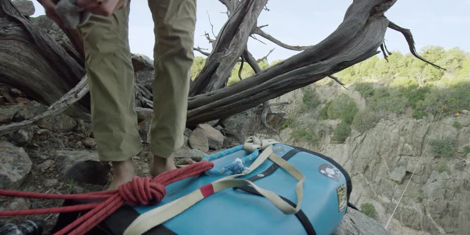 Man removes his socks in the wilderness