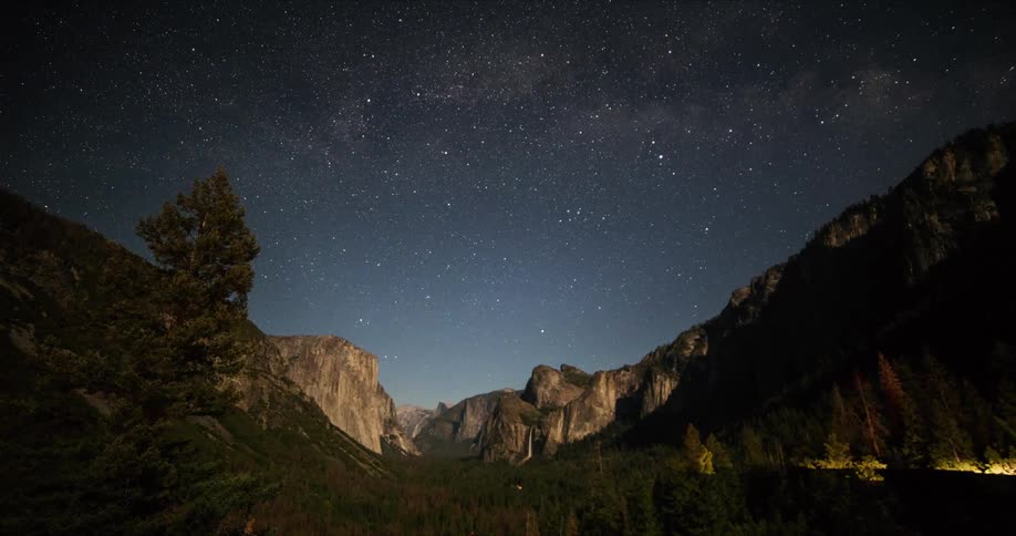 Time lapse of shooting stars over a canyon at night