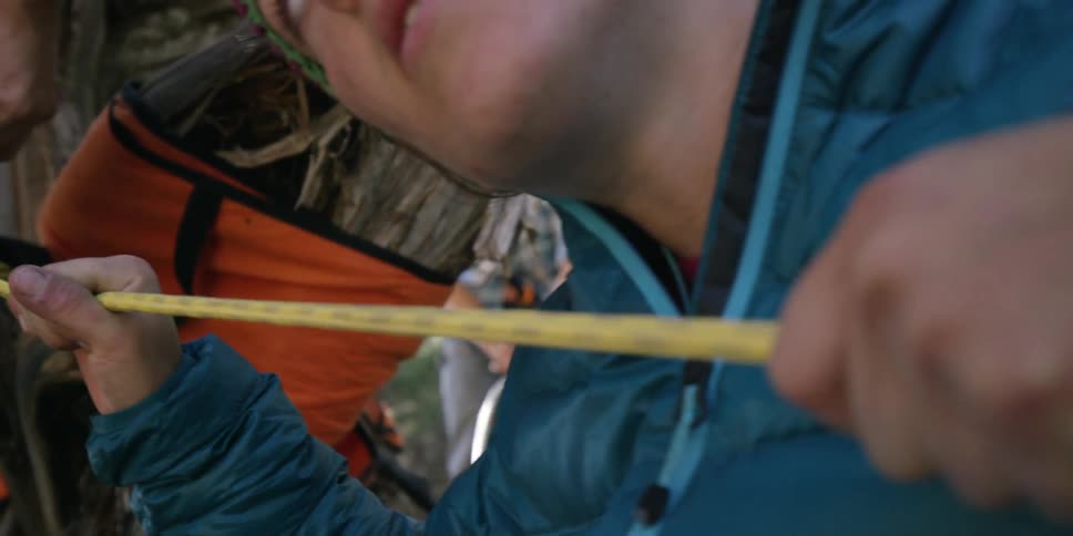 A man is running a rope through his hands