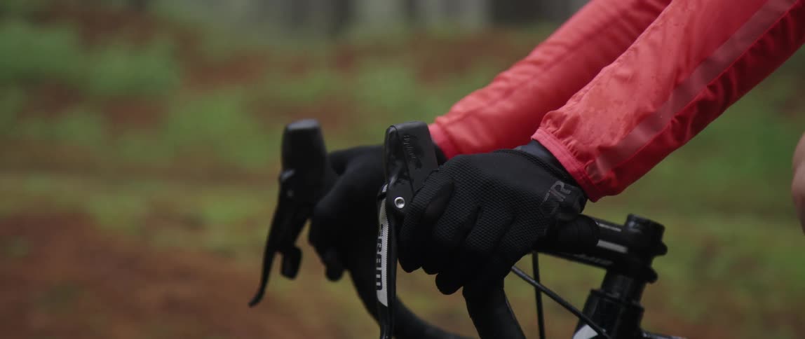 close up side tracking shot of cyclists hands on the handlebar