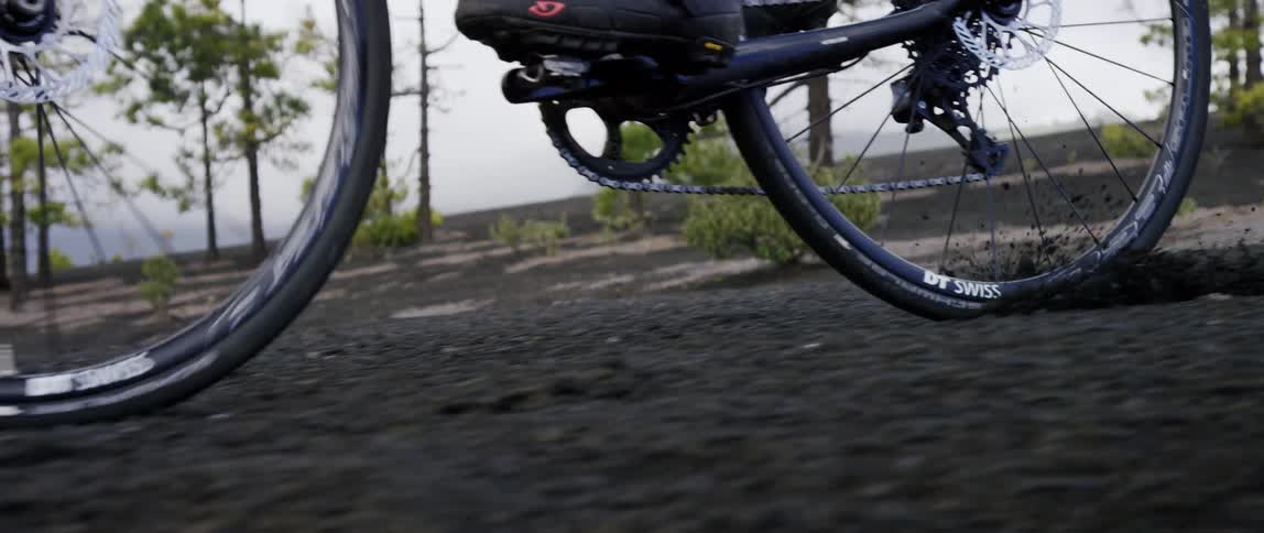 epic tracking shot of bicycle steering and breaking with a locked wheel going downhill