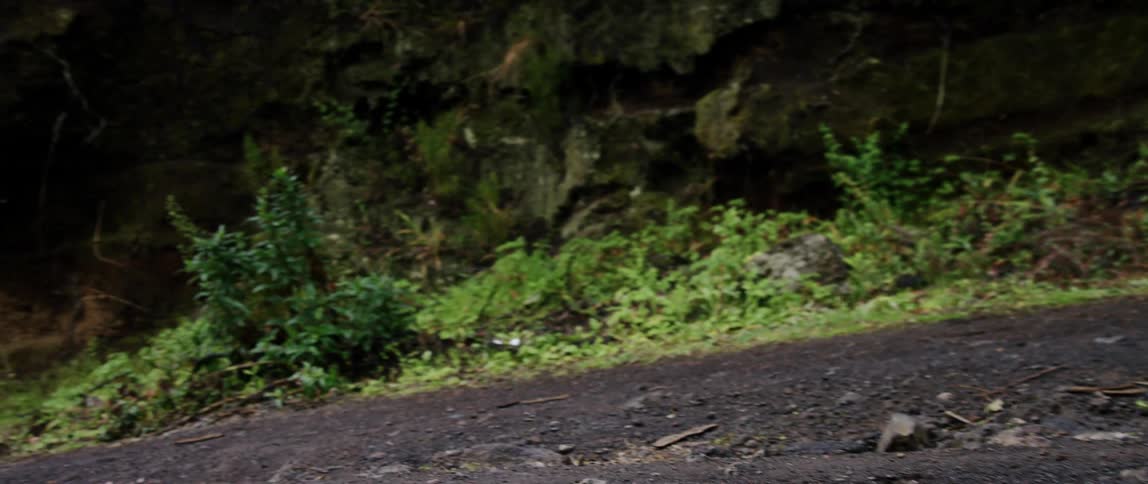 cyclist traverses from paved tarmac road onto gravel dirt road