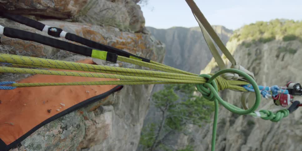 Taught ropes attached to a rock-face stretch out over a gorge