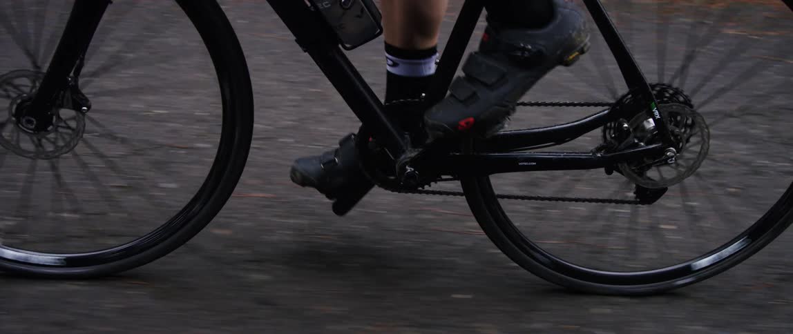 close up of cyclist pedaling on a gravel road