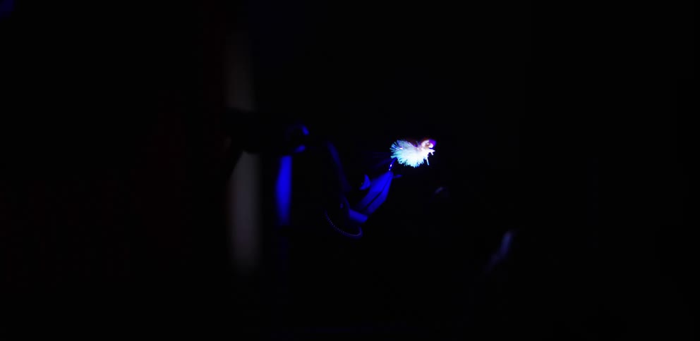 A man indoors working with a tool