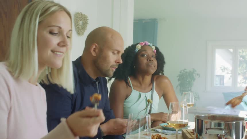 Eating and drinking wine with friends indoors