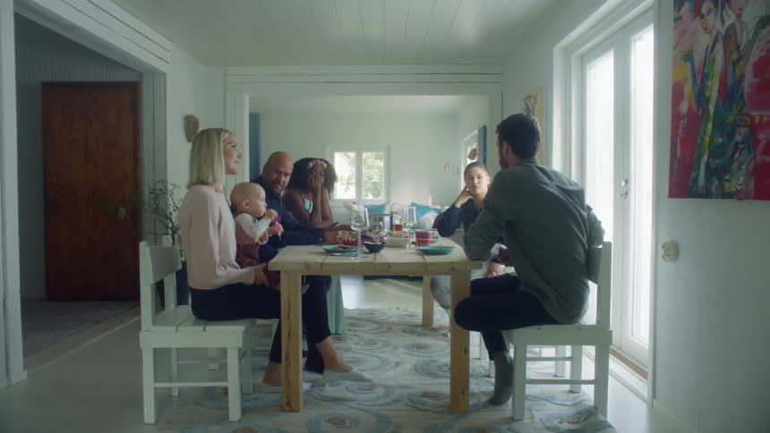 Family and friends having lunch on the dinning table at home