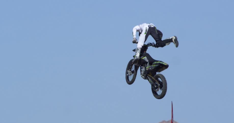 Person makes a jump while riding a dirt bike