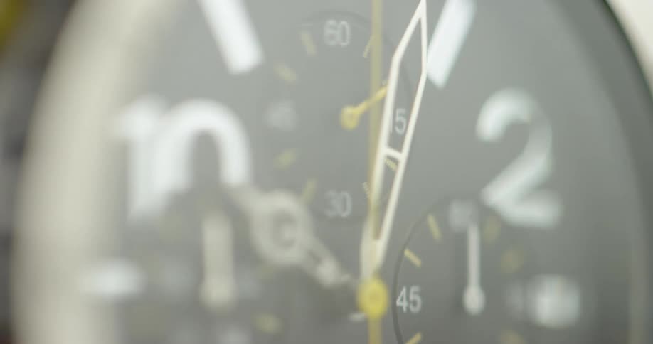 A chronograph watch has white numbers and gold tick marks