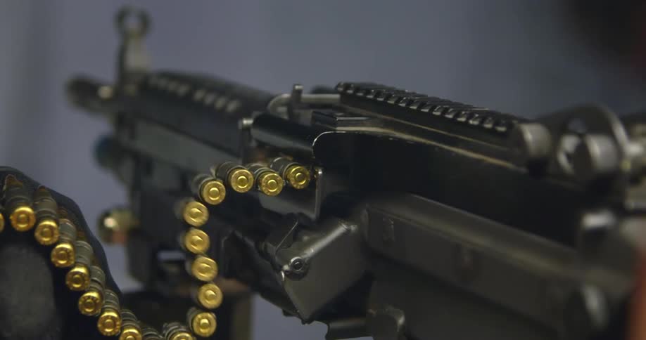 Ammunition belt feeding a machine gun firing on a shooting range