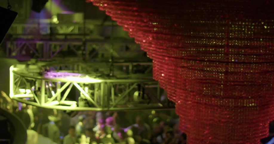 A club with people dancing and views of hanging light fixtures