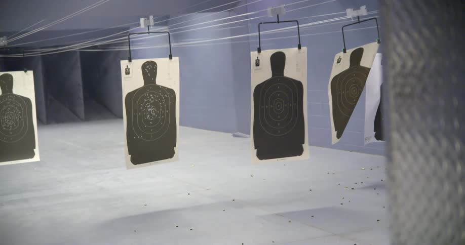 Paper targets hanging from a ceiling at a shooting range