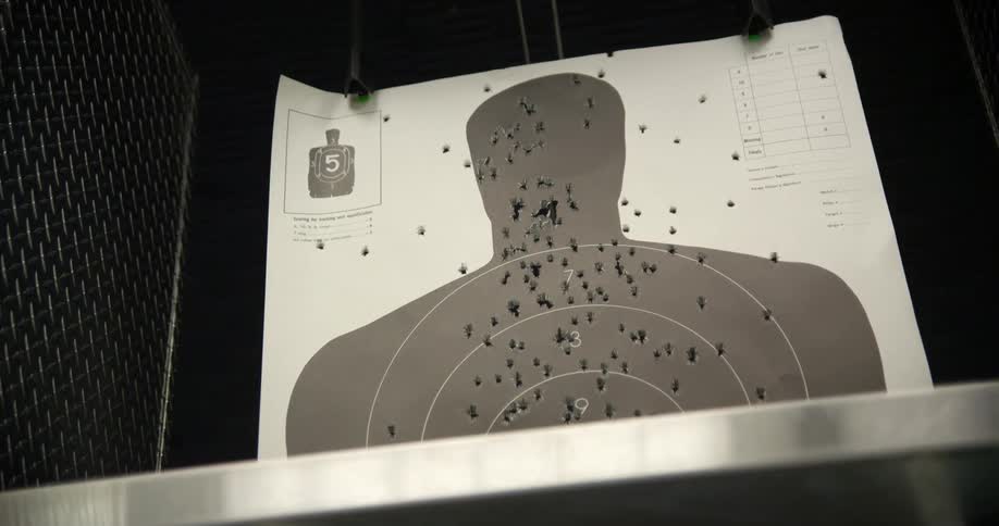 A target with bullet holes all over it with most being on target but some are far off to the sides