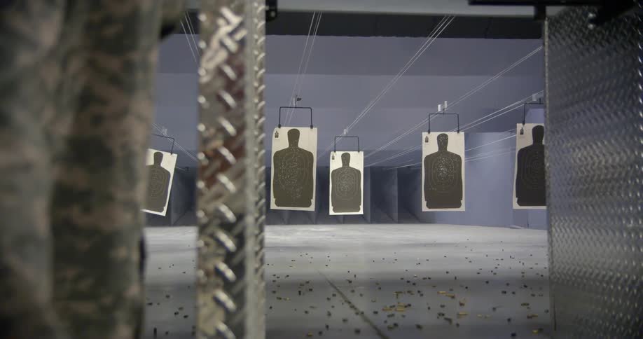 Bullet casings scatter across the floor as people shoot at hanging targets