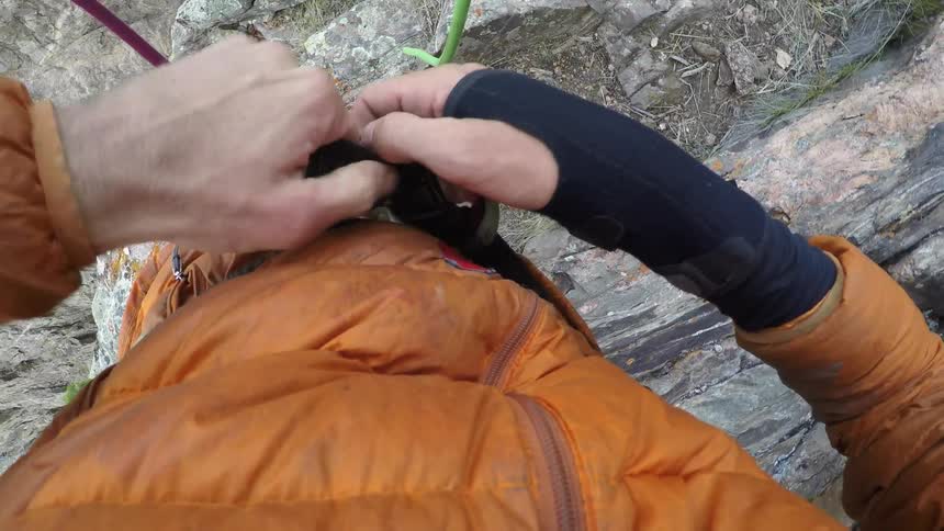 Person tightening the straps on a harness