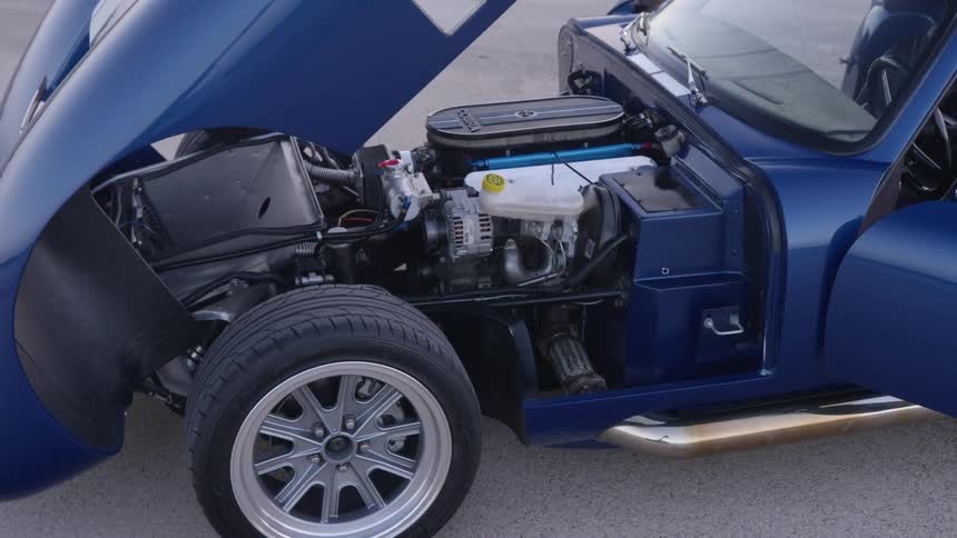 The hood of a race car lifted up exposing the engine